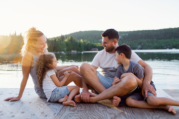 Family on the pier warm summer day having good time