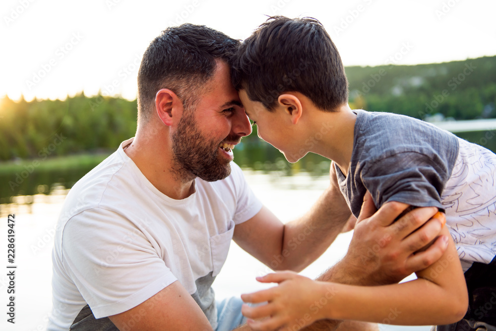 father and son on the pier warm summer day having good time father and son on the pier warm summer day having good time