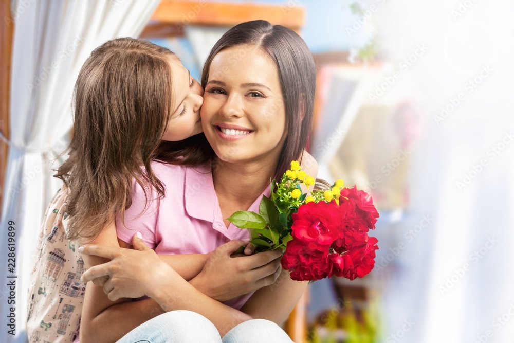 Portrait of happy mother and daughter holding flowers Portrait of happy mother and daughter holding flowers
