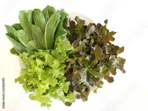 Vegetable salad in a plate placed on a white background.