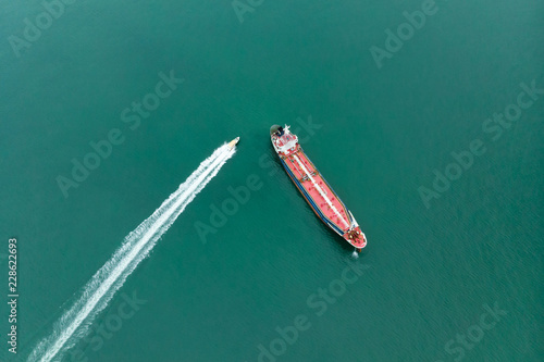 Aerial view of sea freight, Pink Crude oil tanker, LPG, CNG at industrial estate Thailand / Crude Oil tanker to Port of Singapore - import export around in the world. luxury yacht sailing in sea © AU USAnakul+