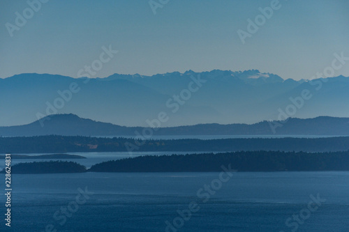 view of the far away island by the sea under the blue haze
