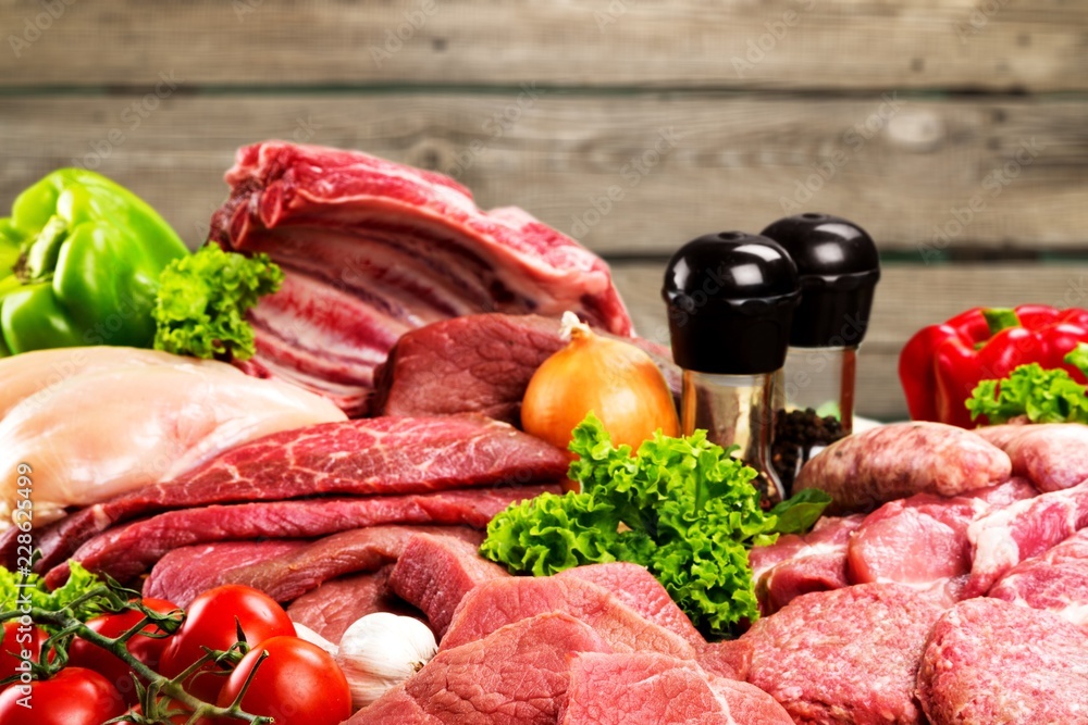 Fresh raw meat with vegetables on brown Fresh raw meat with vegetables on brown