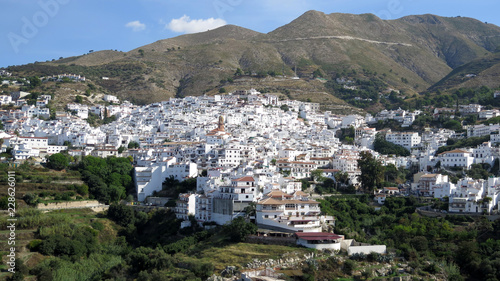 Clock tower on church in white Andalusian village of Competa