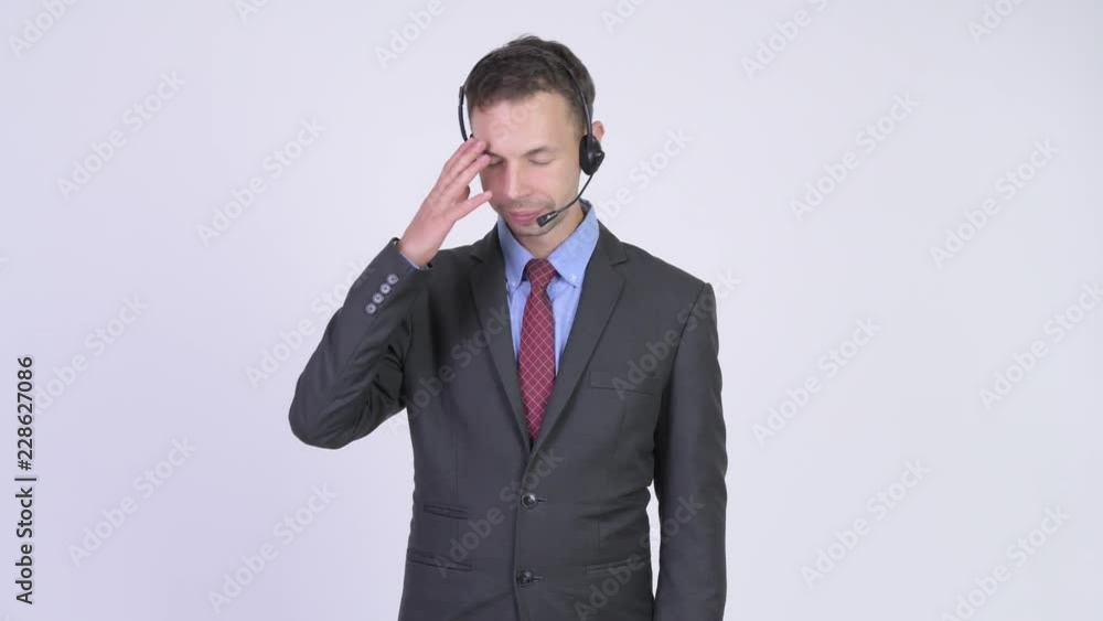 Stressed businessman as call center representative having headache Stressed businessman as call center representative having headache
