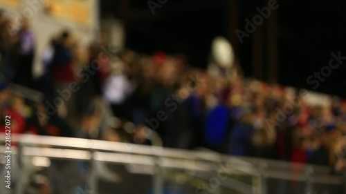 DEFOCUSED CROWD AT FOOTBALL GAME IN STANDS