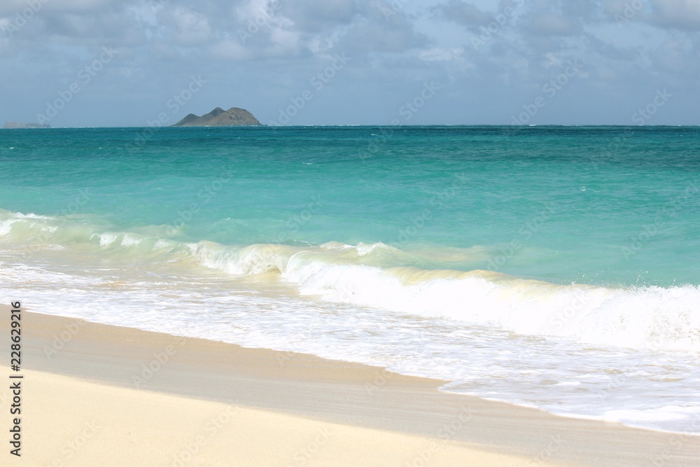 Remote Hawaiian Beach with an Island on the Horizon Remote Hawaiian Beach with an Island on the Horizon