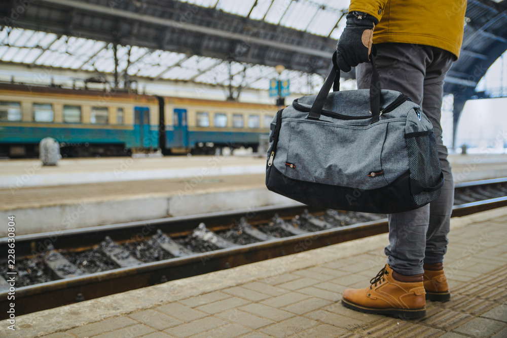 man hold bag close up on railway station man hold bag close up on railway station