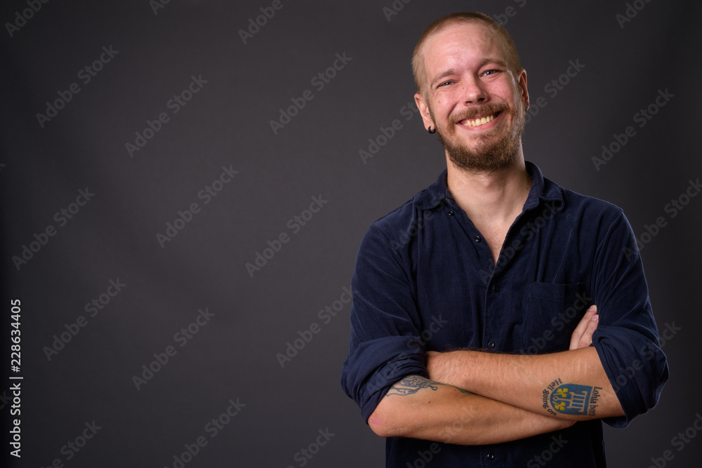Portrait of man against gray studio background