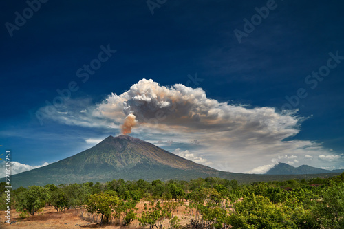 29 June 2018, Bali, Indonesia.Mount Agung volcano dramatic eruption over dark blue sky . Massive clouds of ash higlighted by magma.