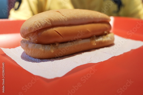 close up of big hotdog on red palte