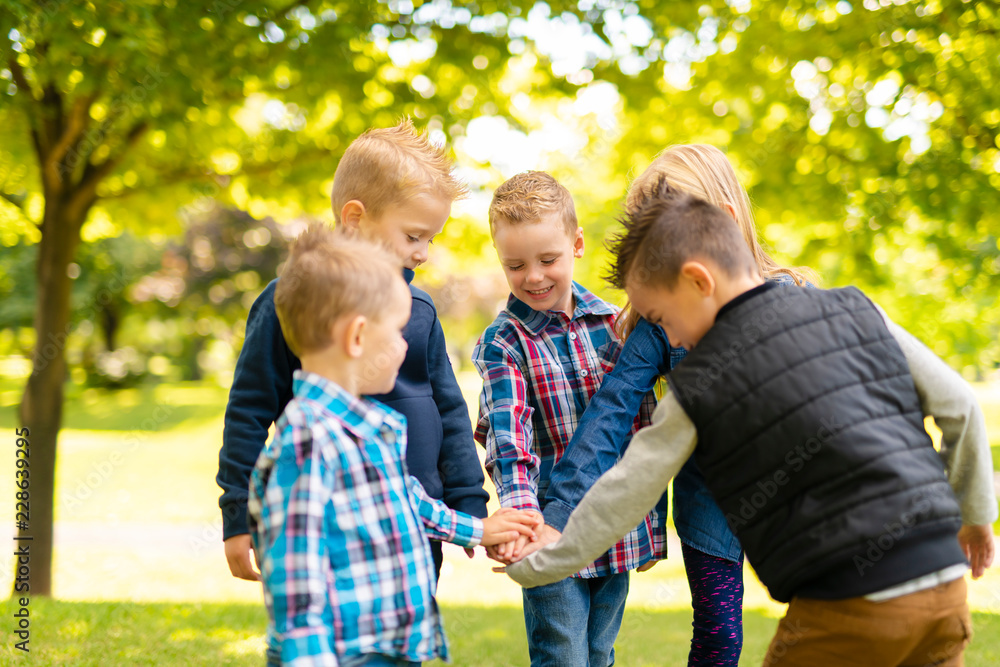 Fototapeta premium A group of children in spring field having fun
