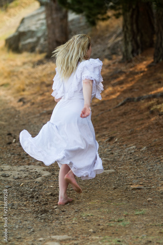girl in white dress running away
