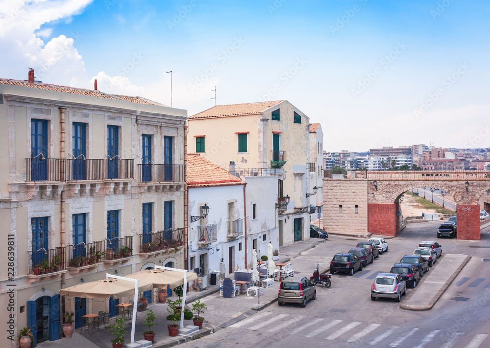 View of old street, facades of ancient buildings in Ortygia (Ortigia) Island, Syracuse, Sicily, Italy