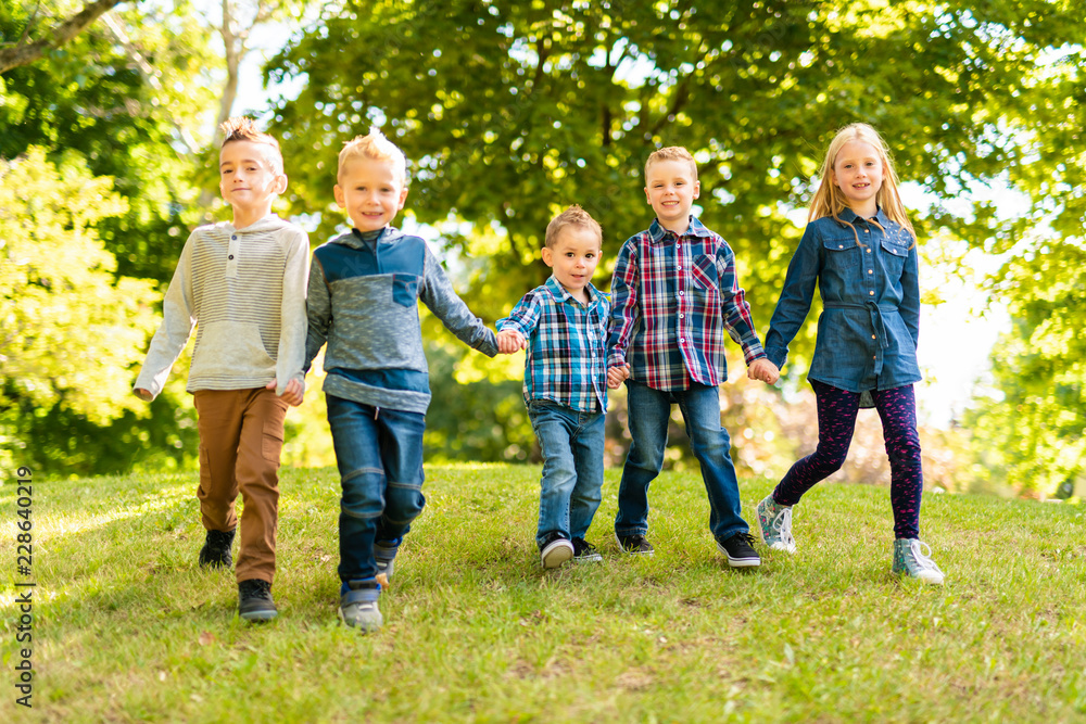 A group of children in spring field having fun A group of children in spring field having fun