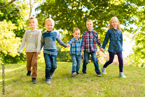 A group of children in spring field having fun