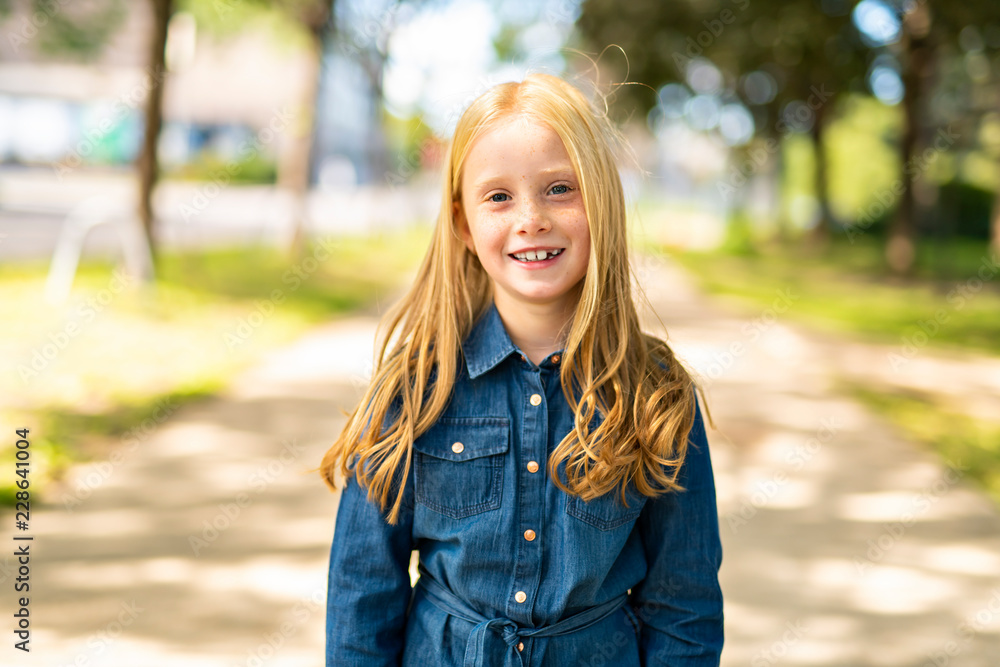 An adorable child girl outside look happy An adorable child girl outside look happy