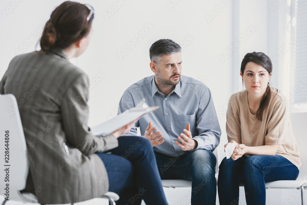 Husband and wife during therapy session with a psychologist Husband and wife during therapy session with a psychologist