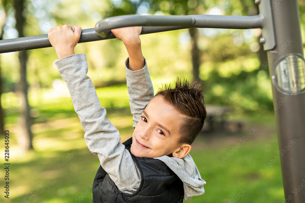 A boy having fun on the park playground A boy having fun on the park playground