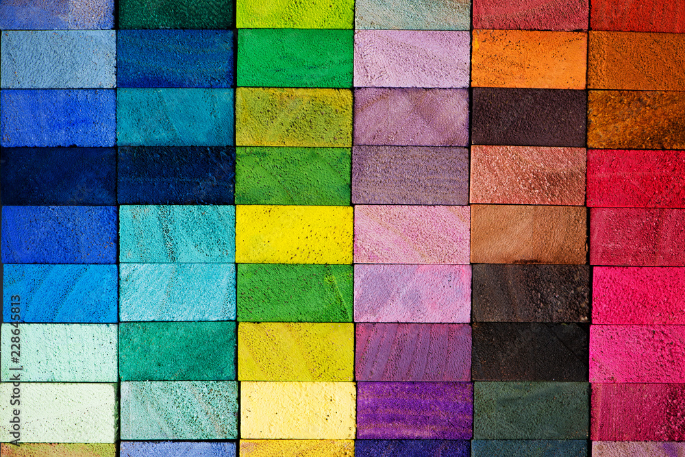 Spectrum of multi colored wooden blocks aligned. Background or cover for something creative or diverse.