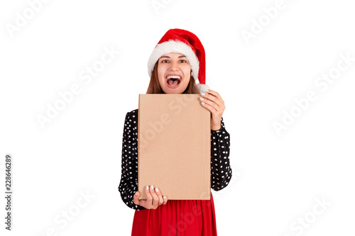 cute girl in chistmas hat hugging her gifts and looking at camera. isolated on white background. holidays concept