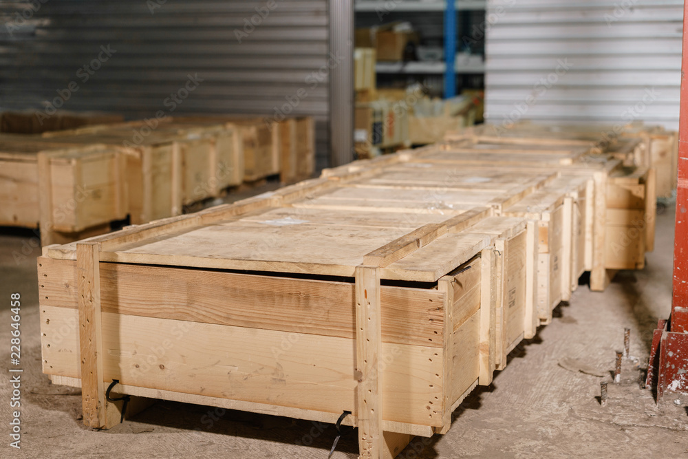 Large wooden boxes. Warehouse of spare parts for machines and mechanisms. Production of ventilation and drainpipe Large wooden boxes. Warehouse of spare parts for machines and mechanisms. Production of ventilation and drainpipe