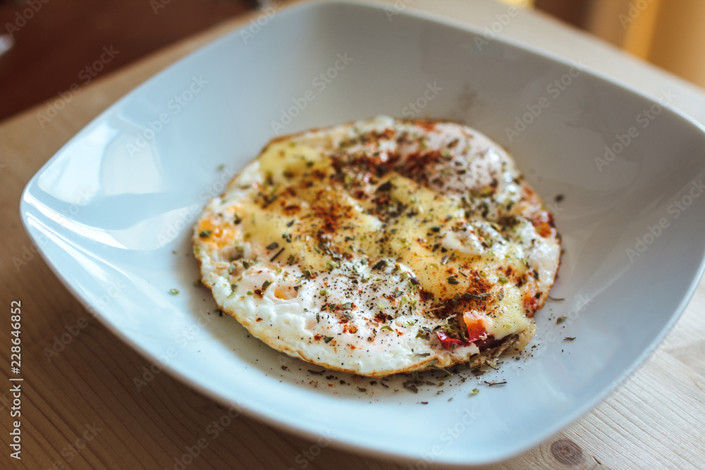 Fried eggs with cheese and spices Fried eggs with cheese and spices