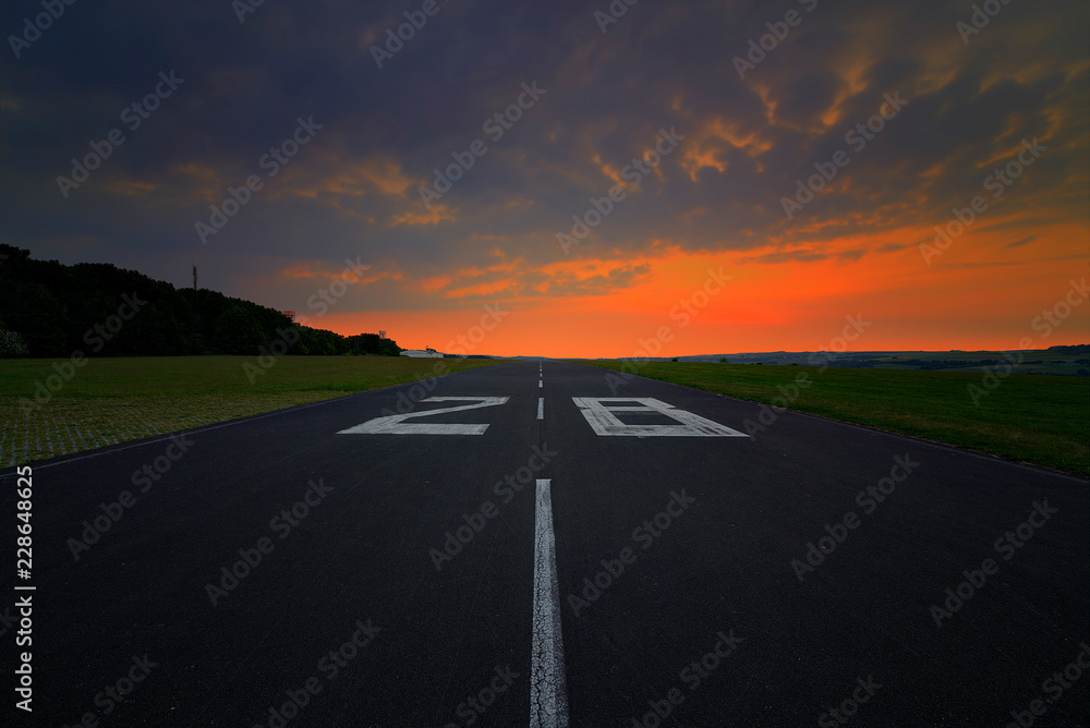 Runway of an airport in the sunset