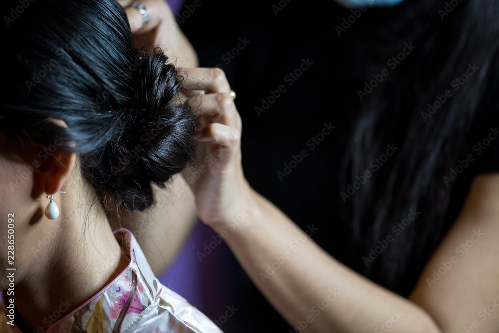 Fototapeta premium Women's haircut. hairdresser, beauty salon.soft and blur style for background.blur image of people at haircut shop.Stylist makes makeup bride on the wedding day.