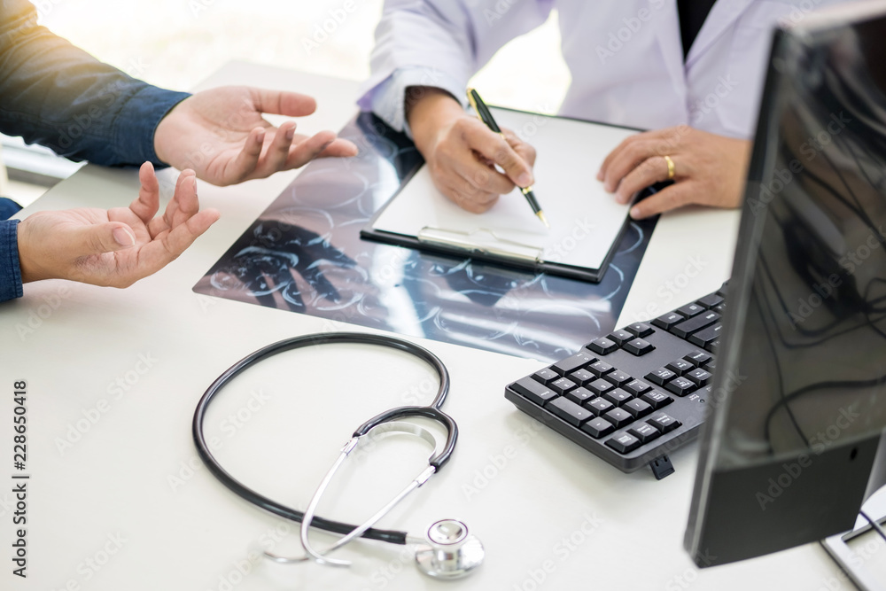 doctor giving a consultation discussing to patient and explaining medical informations and diagnosis, Medicine and health care concept doctor giving a consultation discussing to patient and explaining medical informations and diagnosis, Medicine and health care concept