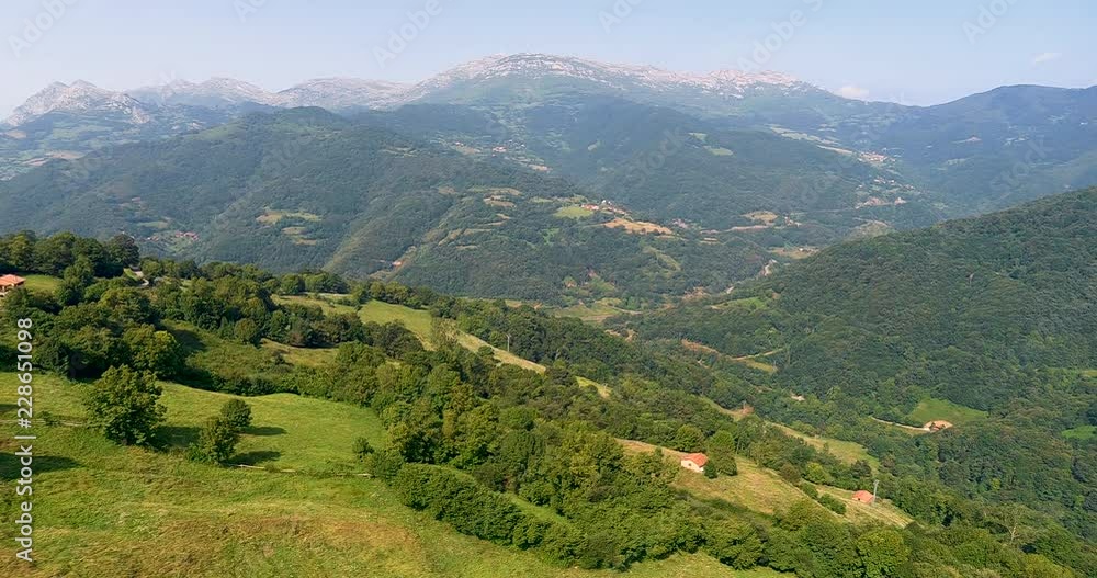 Flying over mountains and a forests with mountains in the front Flying over mountains and a forests with mountains in the front