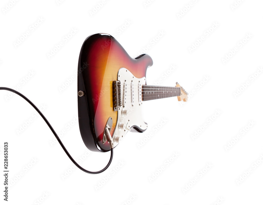 Fototapeta premium Sunburts double cutaway elctric guitar plugged in, isolated on white.