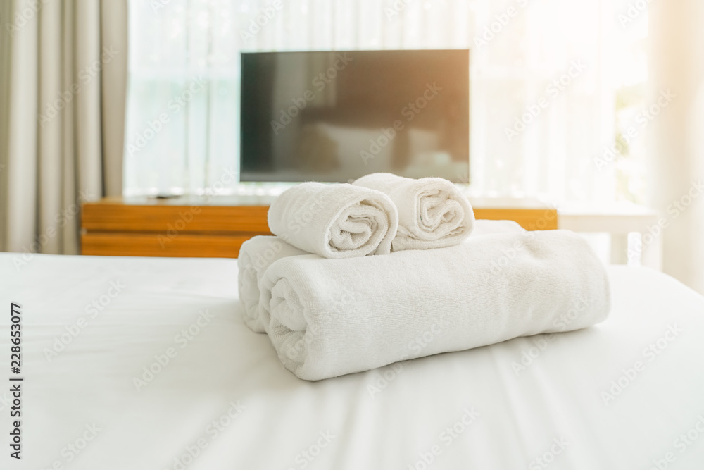 white towels on bed for hotel customer