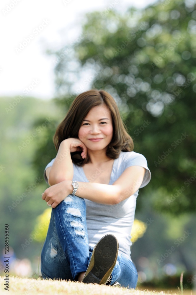 Asian girl portrait model photo in the park outdoor in a sunny summer day, Have a beautiful day and smiling peoples concept.