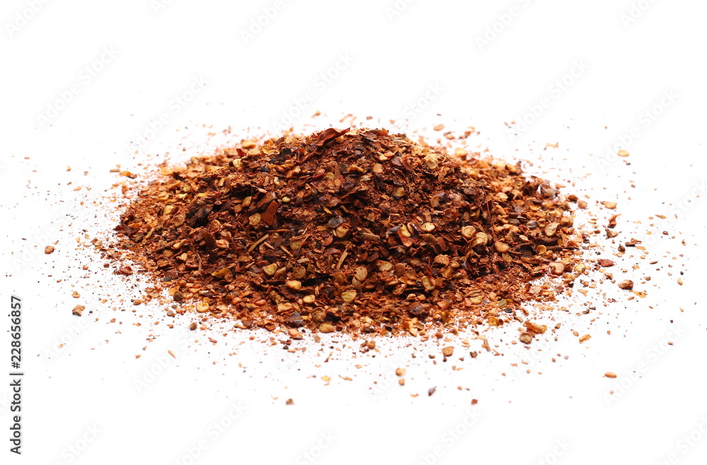 Crushed, ground red cayenne pepper, dried chili flakes and seeds isolated on white background Crushed, ground red cayenne pepper, dried chili flakes and seeds isolated on white background