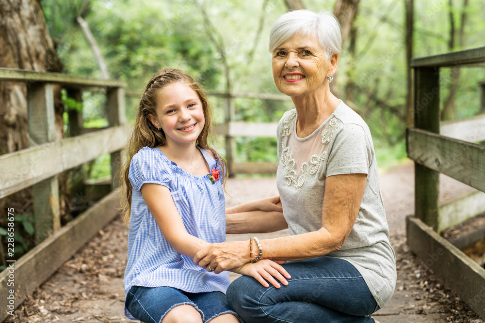 Fototapeta premium Grandmother and granddaughter spend the weekend in the park