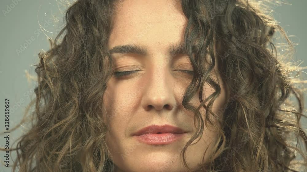 Close-up of woman meditating with closed eyes, awaken opens eyes staring camera Close-up of woman meditating with closed eyes, awaken opens eyes staring camera