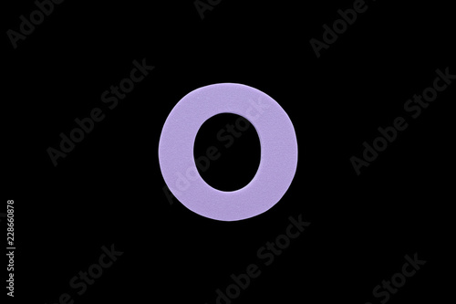 Alphabet letter O symbol of sponge rubber isolated over black background.