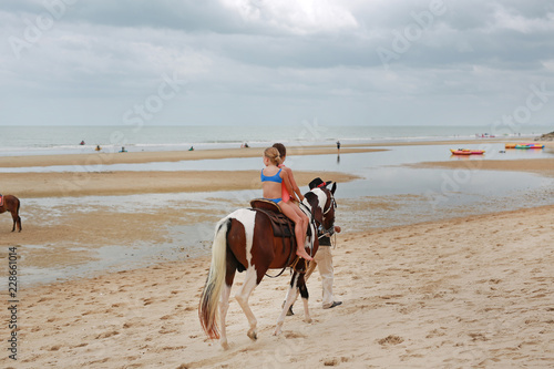 Kids girl rides on horse at beach. Huahin thailand.