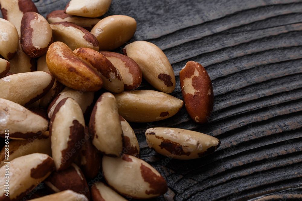 brazil nut on a dark rustic wooden background brazil nut on a dark rustic wooden background