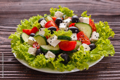 Greek salad on a wooden rustic background