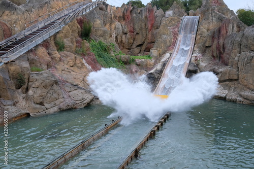 A descent from the top of the volcano down to the lake. Beautifully flying water splashes. Hidden in the heart of the Polynesia PortAventura jungle. photo