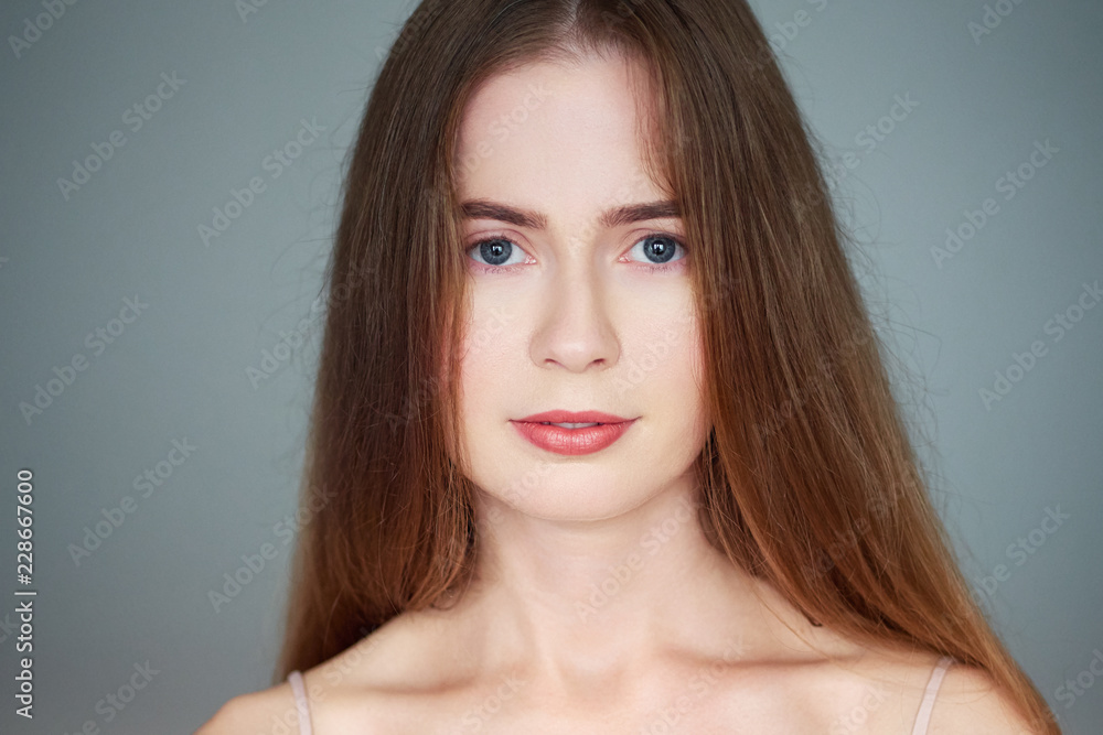 Natural light close up beauty portrait of beautiful blond woman with blue eyes long hair bare shoulders looking at camera Natural light close up beauty portrait of beautiful blond woman with blue eyes long hair bare shoulders looking at camera
