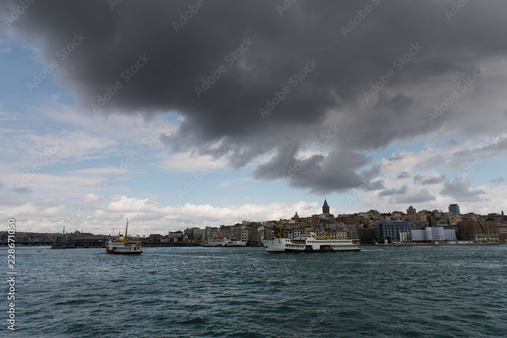 ouristic boats in Golden Horn bay of Istanbul and view on Galata tower, Turkey