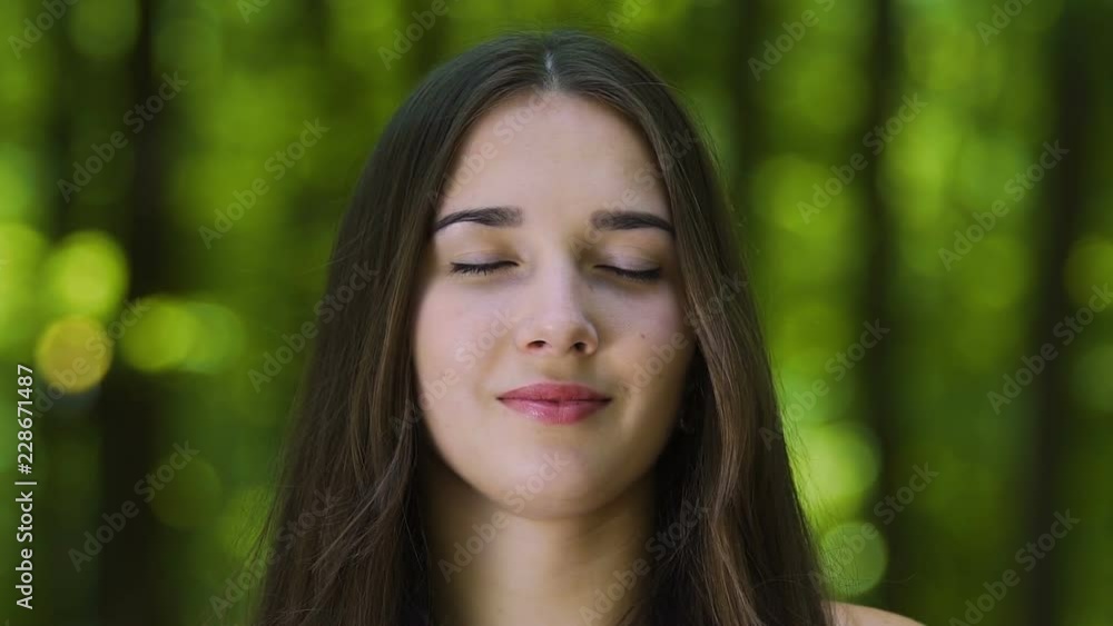Zoom in meditating woman with blessed smile, inner temple female zen outdoors Zoom in meditating woman with blessed smile, inner temple female zen outdoors