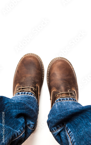 Men's brown boots and blue jeans isolated