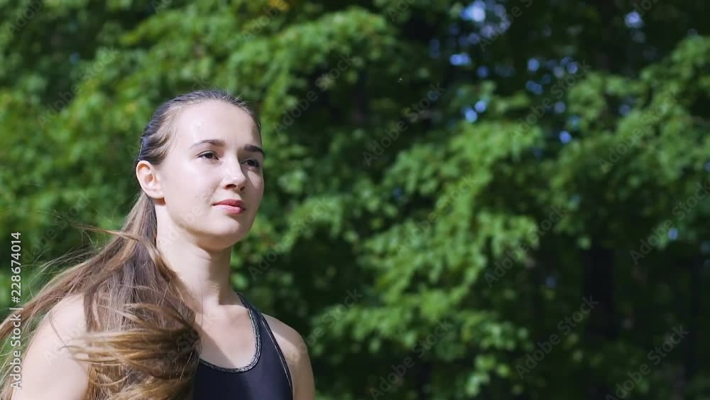 Woman with long hair runs in park slow motion, beautiful female runner outdoors Woman with long hair runs in park slow motion, beautiful female runner outdoors