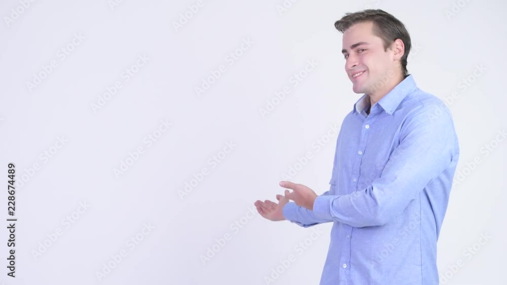 Young happy handsome businessman showing something Young happy handsome businessman showing something