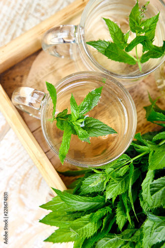 Hot herbal mint tea drink in glass mug