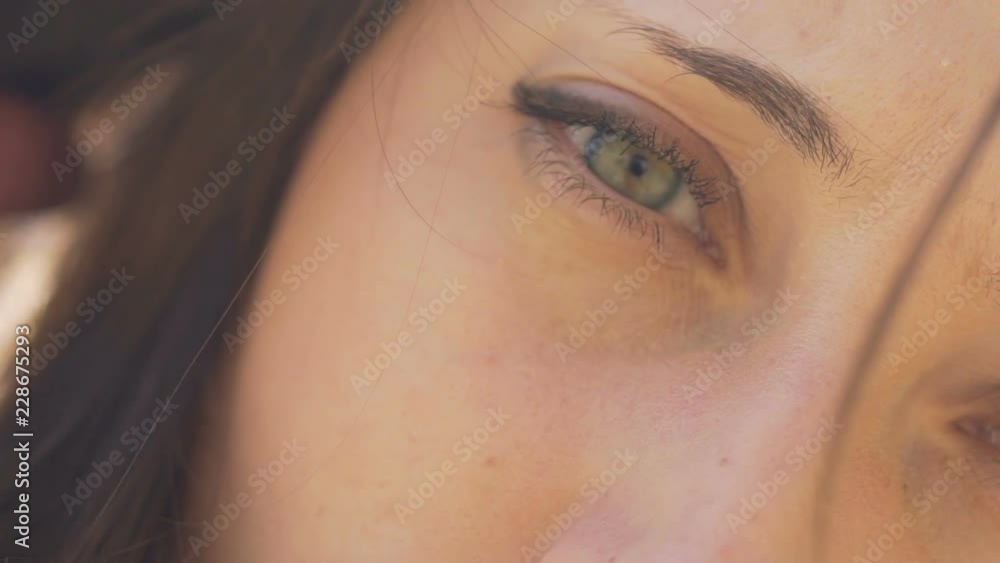 Woman face in haze, beautiful female in sun rays loving eyes serious look slow Woman face in haze, beautiful female in sun rays loving eyes serious look slow